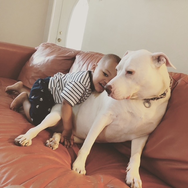 Rae cuddling with a little one on the couch